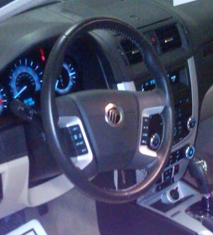 A detailed vehicle interior with a clean dashboard, gauges and steering wheel